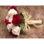 Bouquet of red and white roses with a rustic twine wrap.