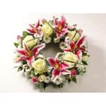 Floral wreath with white roses and pink lilies.