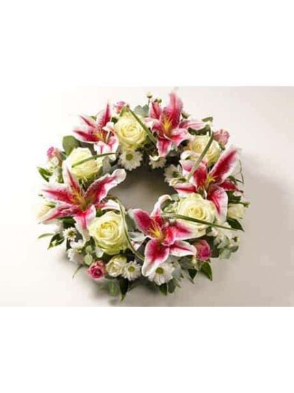 Floral wreath with white roses and pink lilies.
