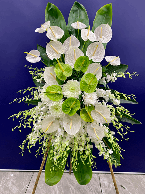 Green and White Standing Spary White orchid floral arrangement for funeral & sympathy — Flower Empire Aurora florist serving