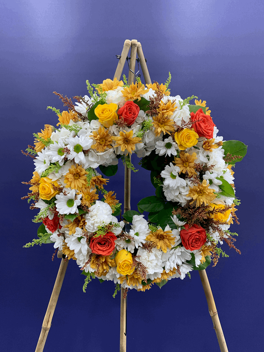 Orange and Yellow Wreath Spray Yellow rose wreath for funeral & sympathy — Flower Empire Aurora florist serving Oakville