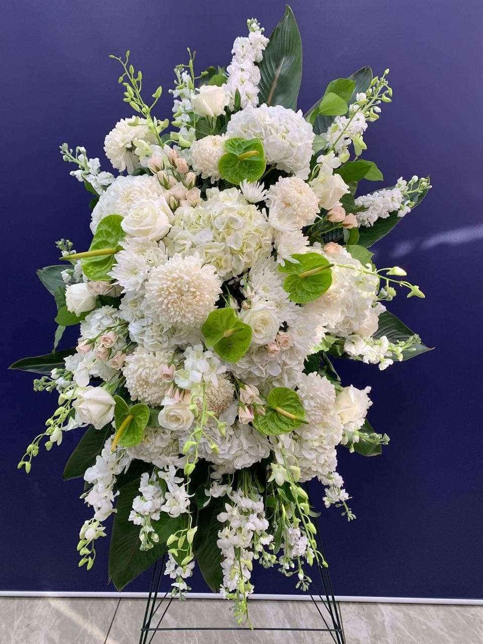 Surrounded by Love Standing Spray White orchid standing spray for funeral & sympathy — Flower Empire Aurora florist serving N