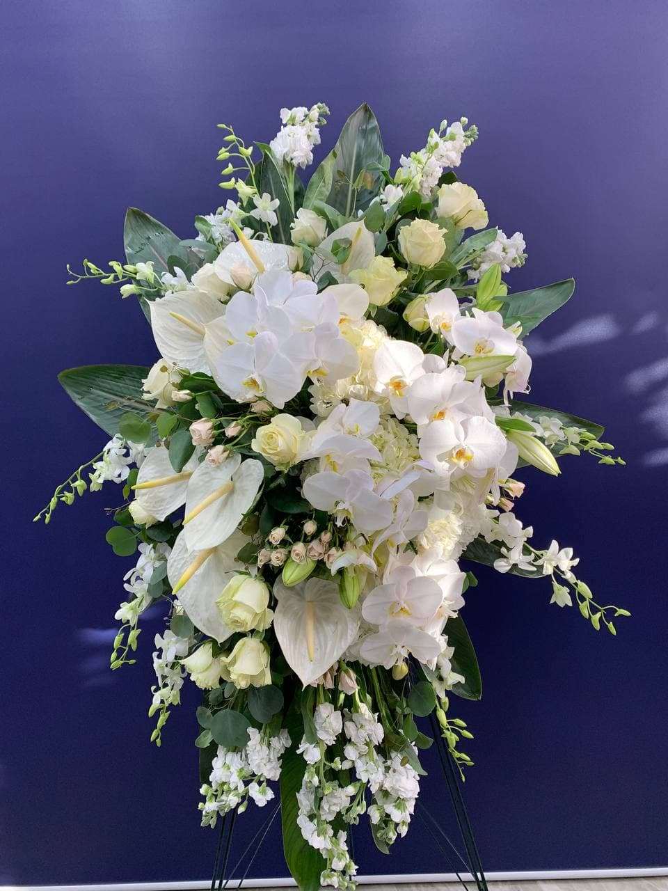 All About White Standing Spray ( White orchid standing spray for funeral & sympathy — Flower Empire Aurora florist serving Oa