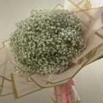 Pure baby's breath bouquet (Gypsophila) wrapped in white and gold paper with pink ribbon streamers — Flower Empire.