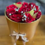 Compact red-rose arrangement with baby's breath and gold butterflies in a luxe gold box — Flower Empire.