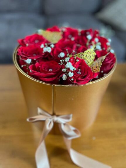 Compact red-rose arrangement with baby's breath and gold butterflies in a luxe gold box — Flower Empire.