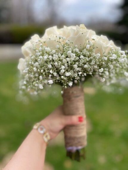 White roses and baby's breath bridal bouquet with rustic burlap-twine wrapped handle.