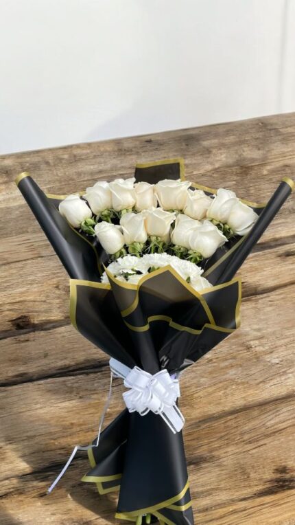 Elegant white-rose bouquet with black and gold wrapping paper — sympathy or wedding style by Flower Empire.