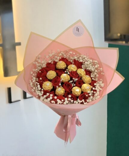 Red roses and gold-wrapped chocolates in pink wrapping
