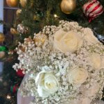 Ivory roses surrounded by baby's breath with white ribbon
