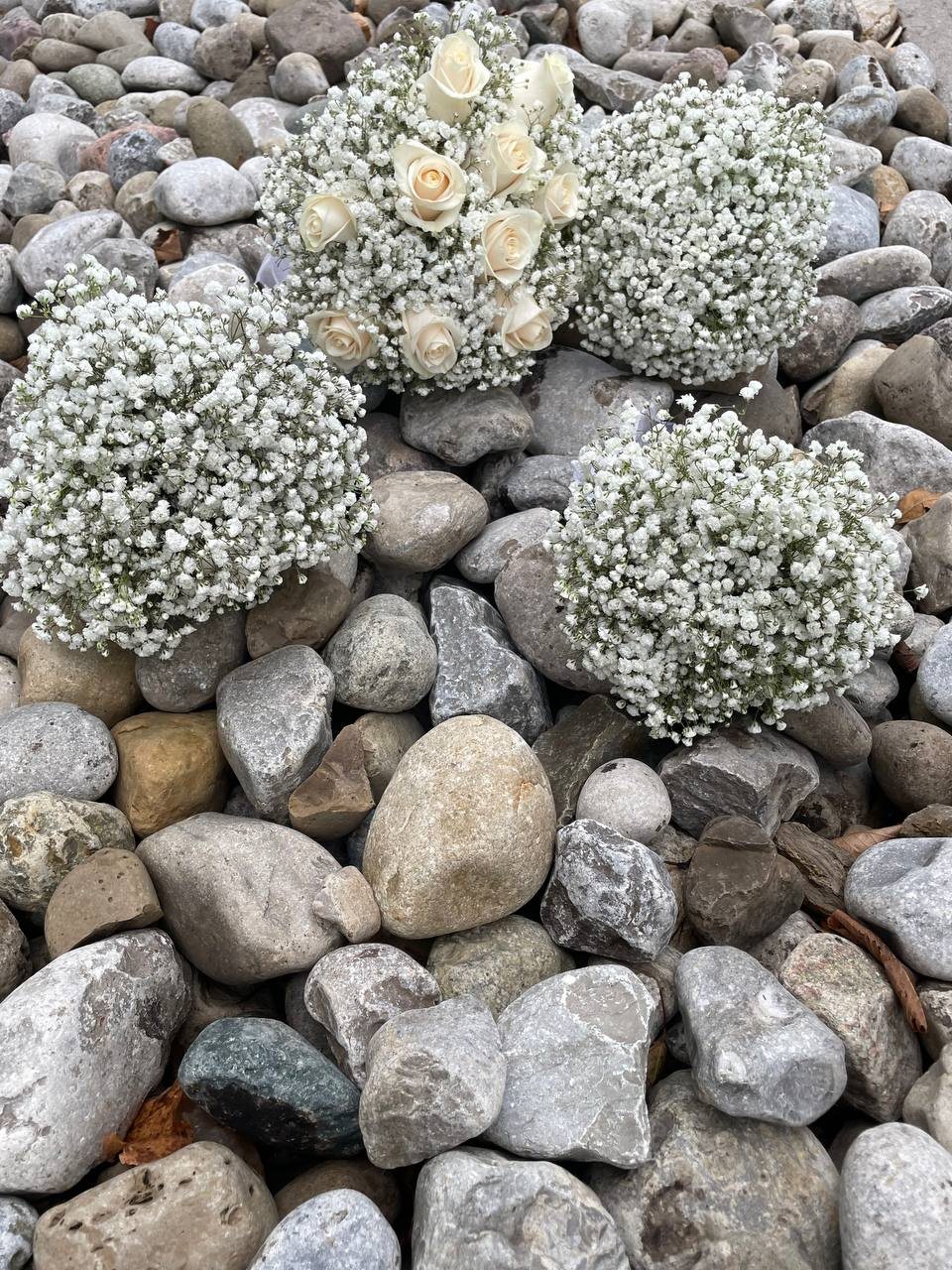 A coordinating collection of baby’s breath posies and white rose wedding flowers. A coordinating collection of baby’s breath posies and white rose wedding flowers.