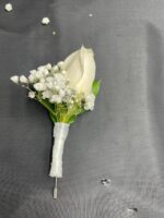 A white rose with baby’s breath and green foliage on a white-wrapped stem.