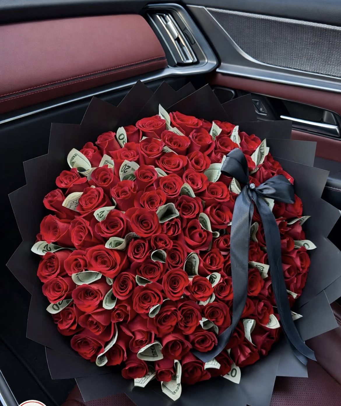 Red roses with rolled banknotes and dark wrapping, shown in a supplied reference screenshot. Red roses with rolled banknotes and dark wrapping, shown in a supplied reference screenshot.